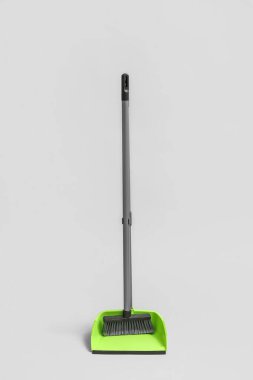 Dustpan with cleaning broom on white background