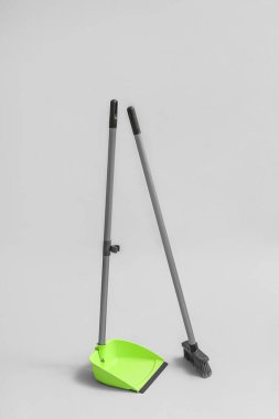Dustpan with cleaning broom on white background