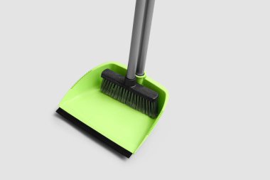 Dustpan with cleaning broom on white background