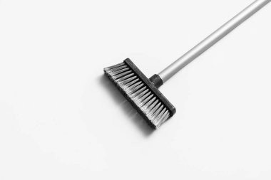 Sweeping broom on white background