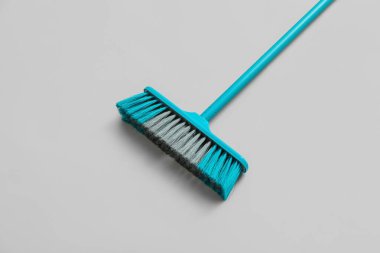 Blue sweeping broom on white background
