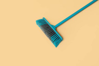 Cleaning broom on orange background