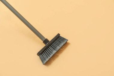Broom for cleaning on color background