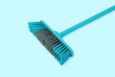 Cleaning broom on blue background
