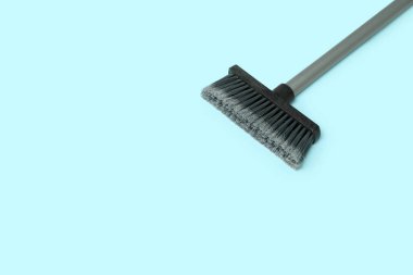 Plastic sweeping broom on color background