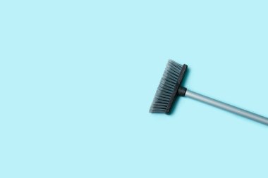 Plastic sweeping broom on color background