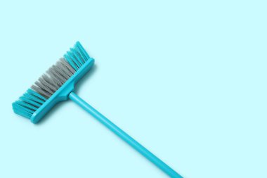 Cleaning broom on blue background
