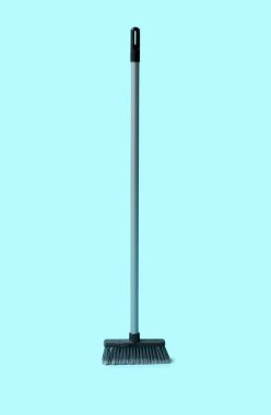 Plastic sweeping broom on color background