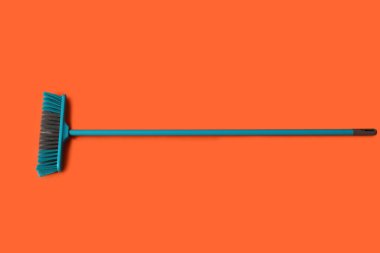 Blue broom for cleaning on color background