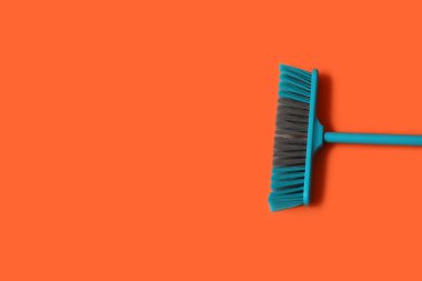 Blue broom for cleaning on color background