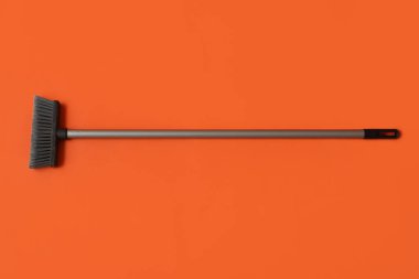 Sweeping broom on color background