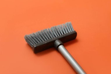 Sweeping broom on color background