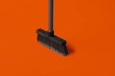 Plastic cleaning broom on color background