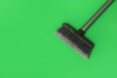 Cleaning broom on green background