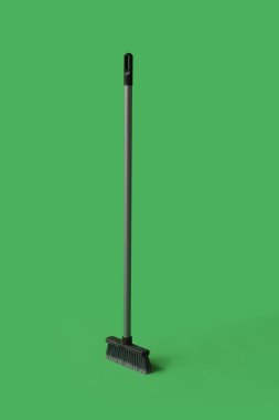 Cleaning broom on green background