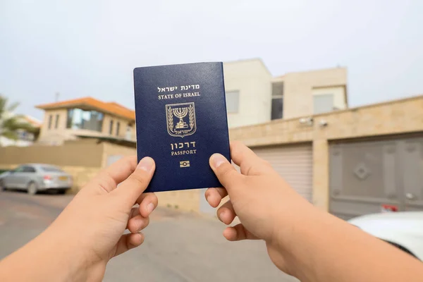 Child with passport of Israel in city, closeup