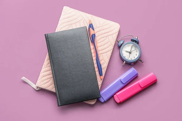 Notebooks Pen Markers Alarm Clock Lilac Background — стоковое фото