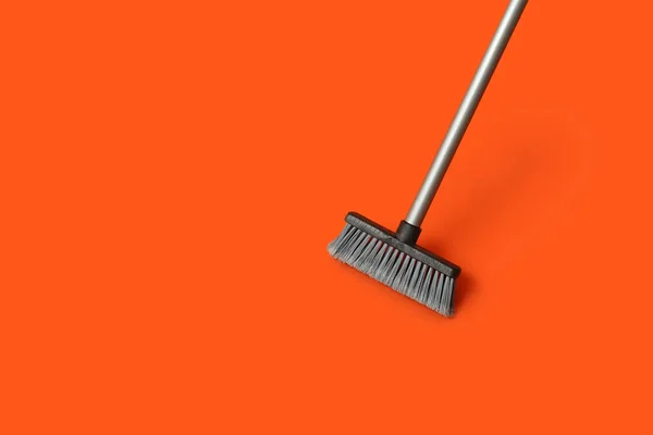 Plastic cleaning broom on color background