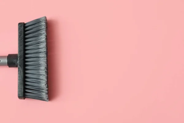 Plastic cleaning broom on pink background