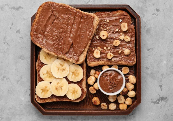 Wooden Board Tasty Toasts Hazelnut Butter Banana Nuts Light Background — Stock Photo, Image
