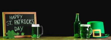 Banner with green beer, chalkboard and leprechaun's hat on dark background. St. Patrick's Day celebration 