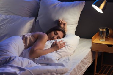 Beautiful woman sleeping in bed at night