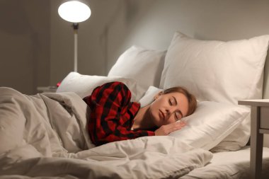 Beautiful woman sleeping in bed at night