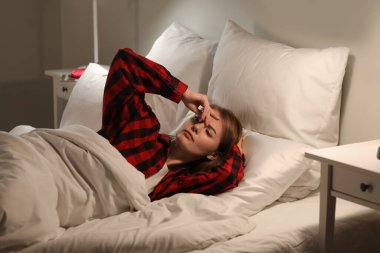 Beautiful woman sleeping in bed at night