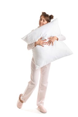 Beautiful woman in pajamas with pillow on white background