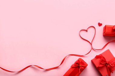 Heart made of ribbon and gifts on pink background. Valentine's Day celebration