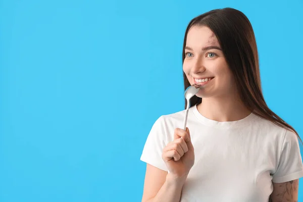 Young Woman Silver Spoon Blue Background — Stock Photo, Image