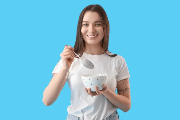 Young Woman Silver Spoon Bowl Blue Background — Stock Photo, Image