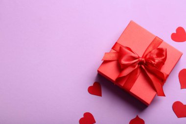 Beautiful gift and paper hearts on pink background. Valentine's Day celebration