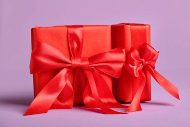 Gift boxes with beautiful bows on pink background. Valentine's Day celebration