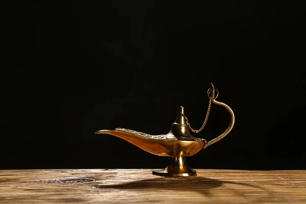 Aladdin lamp of wishes for Ramadan on table against dark background