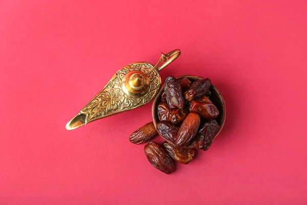 Aladdin lamp of wishes and dates for Ramadan on red background
