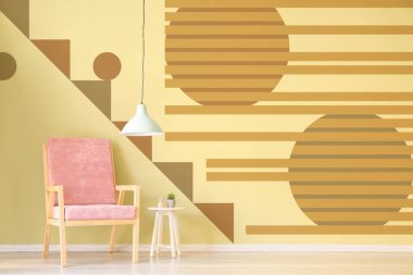 Interior of modern room with armchair and table near yellow wall