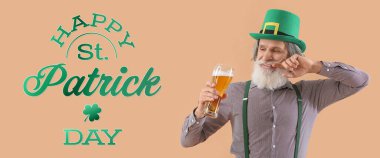 Senior man with glass of tasty beer on beige background. St. Patrick's Day celebration