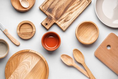 Wooden cooking utensils on grey background