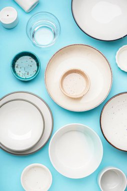 Different clean dishware on blue background