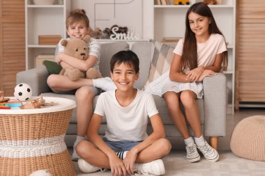 Happy little friends spending time together at home