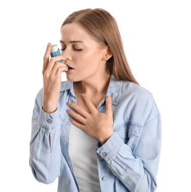 Sick young woman with inhaler on white background