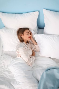 Young woman sleeping at home in morning