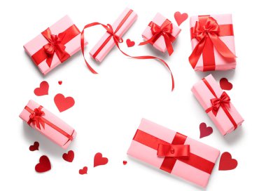 Frame made of gift boxes and paper hearts on white background. Valentine's Day celebration