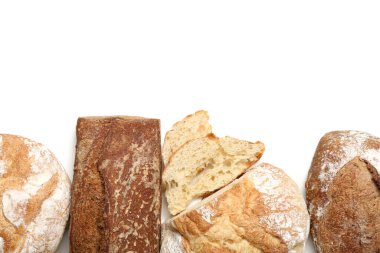 Fresh loaves of different bread isolated on white background