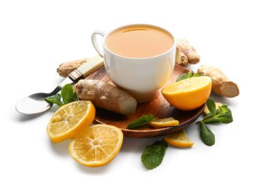 Wooden board with cup of tea, ginger, lemon and mint on white background