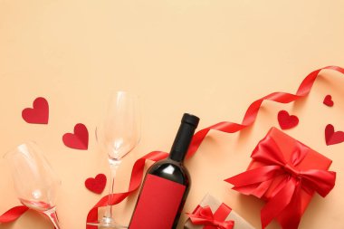 Composition with bottle of wine, gifts, glasses and decor on color background. Valentines Day celebration