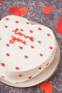 Plate with heart-shaped bento cake on grey background, closeup. Valentine's Day celebration