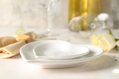Heart-shaped plates on white table. Valentine's Day celebration
