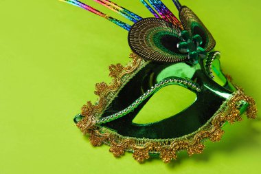 Carnival mask for Mardi Gras celebration on green background